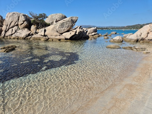 Plage de Tamaricciu, Stunning view of turquoise waters, rocky formations, and pristine white sand at a beach in Porto Vecchio, South Corsica.