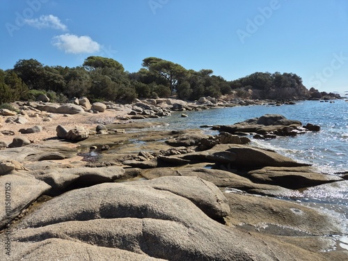 Plage de Tamaricciu, Scenic coastal view showcasing turquoise waters, rocky outcrops, and white sand at a beach in Porto Vecchio, South Corsica.