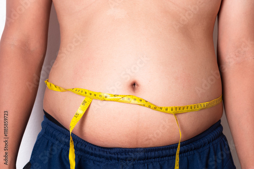 Overweight or obese man on white background. Fat mens body measurements. he is dieting and losing weight. Men at risk for diabetes Belly fat. Healthcare, medicine concept