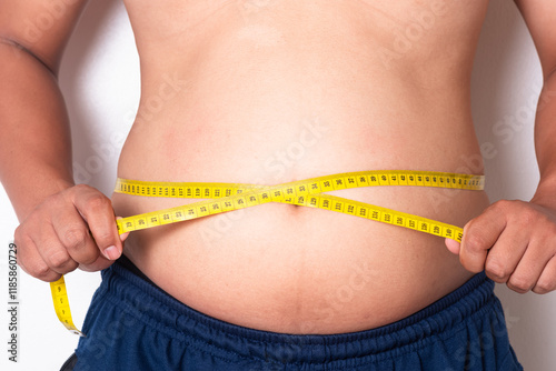 Overweight or obese man on white background. Fat mens body measurements. he is dieting and losing weight. Men at risk for diabetes Belly fat. Healthcare, medicine concept
