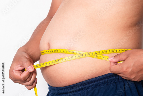 Overweight or obese man on white background. Fat mens body measurements. he is dieting and losing weight. Men at risk for diabetes Belly fat. Healthcare, medicine concept