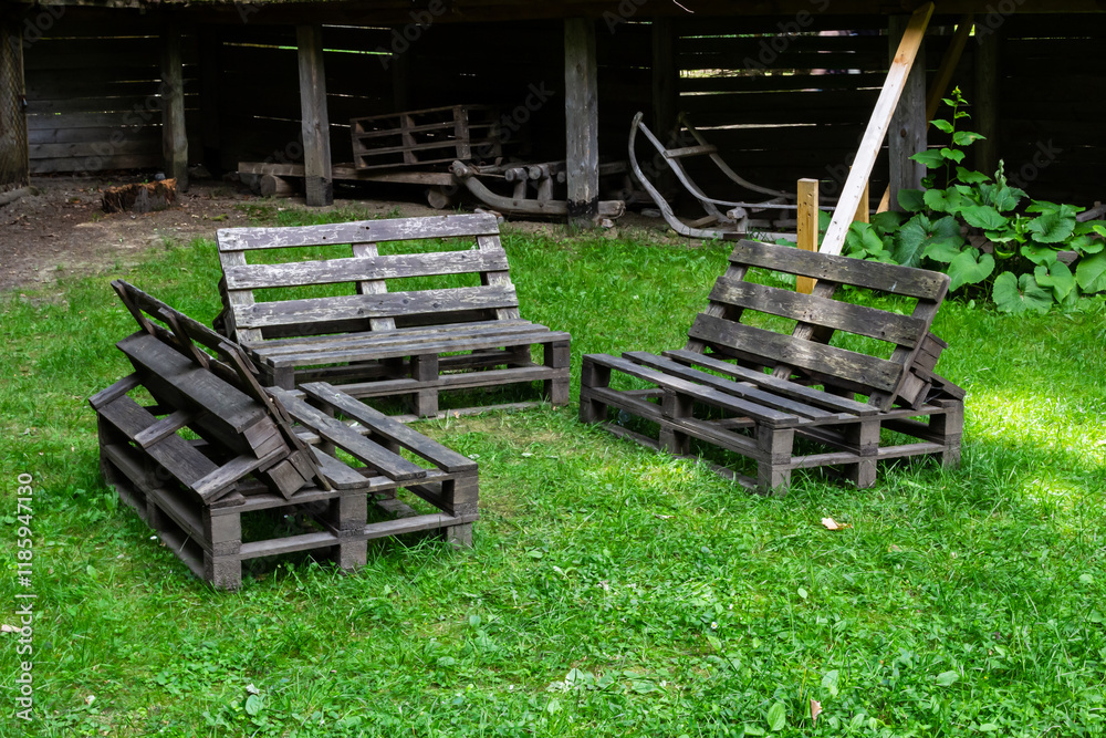 Rustic wooden seating arranged in a grassy area within a traditional outdoor setting Rustic wooden seating arranged in a grassy area within a traditional outdoor setting