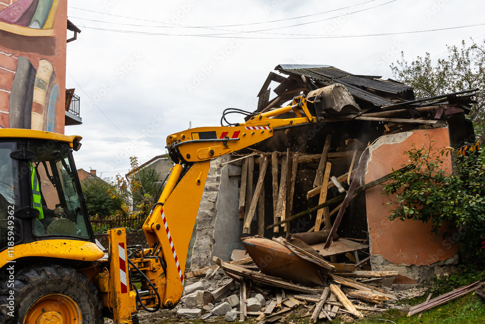 Heavy machinery demolishes a deteriorating building in an urban area during overcast weather Heavy machinery demolishes a deteriorating building in an urban area during overcast weather