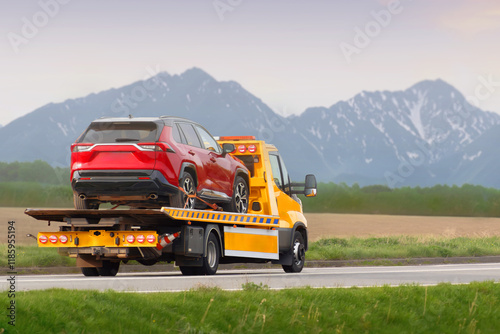 Tow truck hauling car after highway breakdown