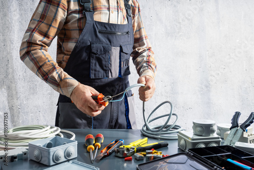A professional electrician connecting wires  on site.