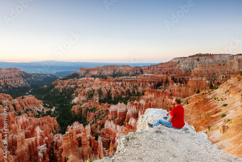 Man on rock near the edge, Bryce Canyon National Park, Utah, United States photo