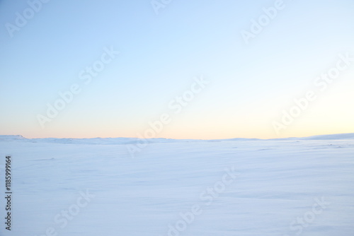 Arctic Sun shining over the Hills close to the north cape in Norway, a desert of ice and snow, sunset all day