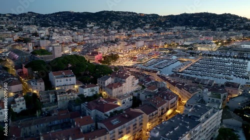 night illumination in Cannes aerial view, famous resort on the French Riviera, the city of Cannes film festival, Cannes harbour with luxury yachts from a drone