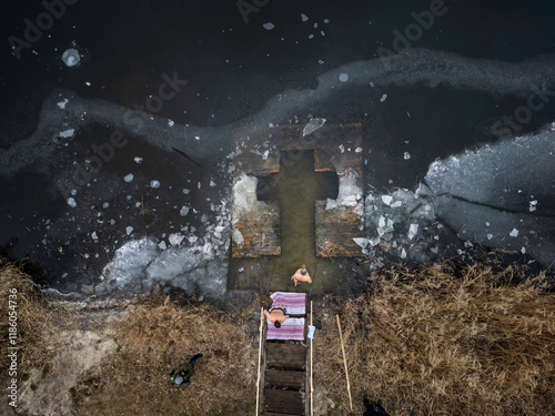 An aerial view shows Ukrainian Orthodox believers bathing in cold water during Epiphany celebrations in Kyiv, Ukraine, on January 06, 2025, amid the ongoing Russian invasion  photo