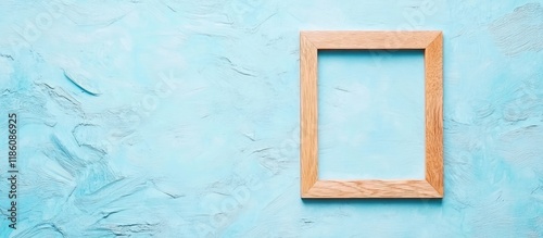 Empty wooden frame on a blu...