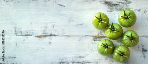 Green unripe tomatoes on a ...