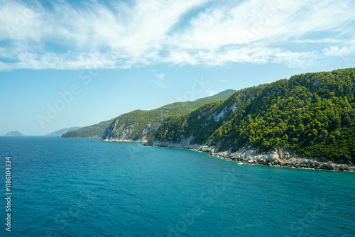 View of the sea, mountains, rocks, beaches, islands and the sky from different sides of the Skopelos island Greece.
