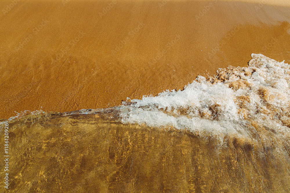 concept for perfumes, smells, heat, freshness, coolness and other associations. Ripple sea ocean water surface with small waves. Ocean water foam splashing. Copy space. sandy beach with waves rolling