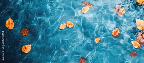 Top view of a blue swimming pool surface with reflections on the blue water swirl pattern texture and blue tiles Leaves in the murky water swimming pool is open Background backdrop with copyspace photo