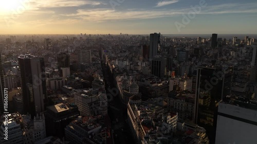 Historic cityscape of Buenos Aires City during golden sunset. Tower and buildings along main street. Drone flyover wide shot. photo