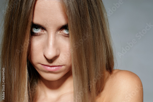 Slika na platnu Close-Up Portrait of a Woman with Intense Stare and Long Hair