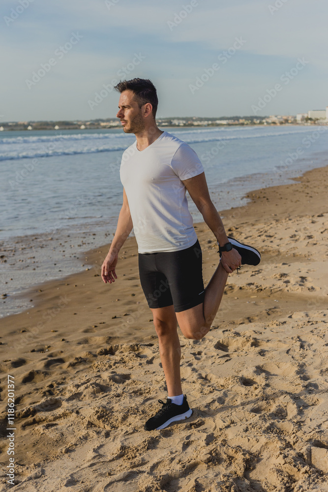 Caucasian man tying shoelaces on the beach after workout Caucasian man tying shoelaces on the beach after workout