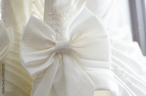 Elegant White Wedding Gown with Decorative Satin Bow Details.. photo