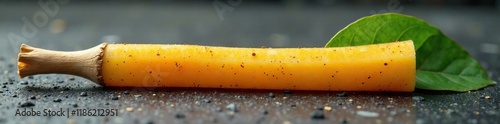 A sugarcane stick on a stone surface with visible juice, stick, leafy, stone photo