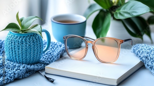 Stylish sunglasses resting on an open book surrounded by potted plants in a c...