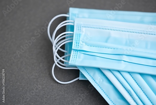 Medical mask with rubber ears on the background. Disposable surgical face mask covering the mouth and nose. Prevent ge 