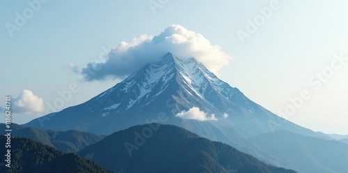 Lone mountain peak shrouded in a wispy white cloud with an inquiring shape, fog, solitude