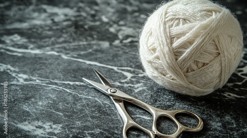 Soft white yarn balls and scissors on a light blue surface during a crafting ...