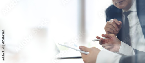 Close up of business team using digital tablet, havie a discussion on business data, accountancy document at office. teamwork and partnership co-working, business solution concept.
