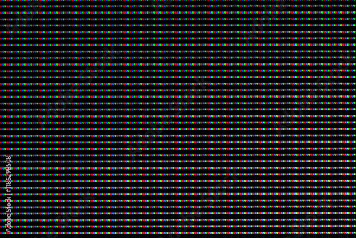 Red, green and blue LEDs on a TV screen close-up. Background of RGB lamps on the screen