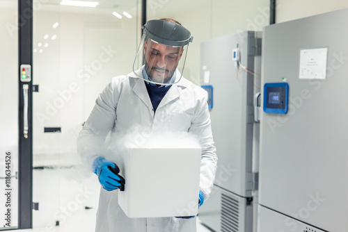 Scientist carrying steaming dry ice box in laboratory photo