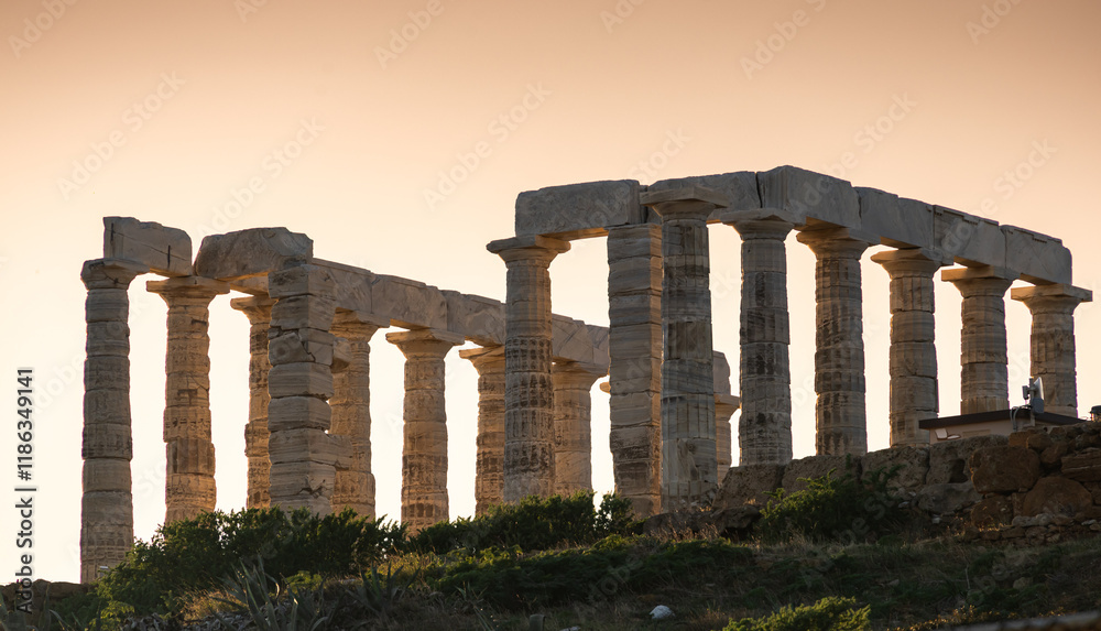 Temple of Poseidon. Beautiful landscape with warm light sky before sunset over Poseidon Temple at Sounion Cape from Greece. Visit and travel to Greece.
