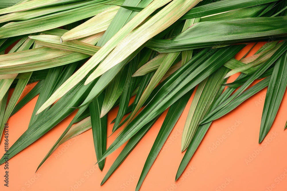 Fototapeta premium Palm leaves with Peach Fuzz color background. pile of green palm leaves on Peach Fuzz color background with copy space. designed for illustration. Palm Sunday illustration 