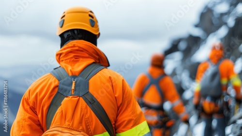 A mountain rescue team rappels down a cliff face to reach stranded climbers.  photo