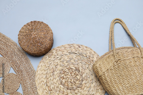 Set of sraw wicker and bamboo items on gray background with copy space. Basket,mat napkin, bag,jute rug. Zero waste concept.