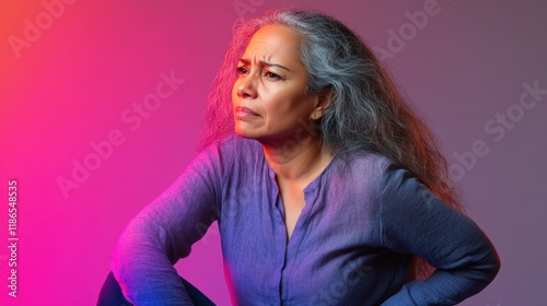 Thoughtful Mature Woman Portrait, Studio Shot,  Purple Lighting, Gray Hair