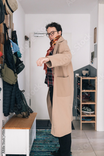 Stylish freelancer wearing a beige coat getting ready to go to work