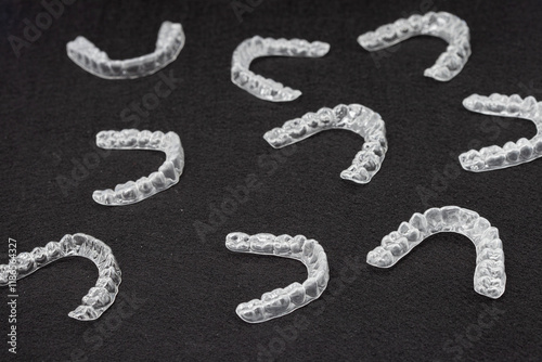 Transparent plastic mouth guard for teeth clenching. Grinding dental bite sleep aid. Dental care.