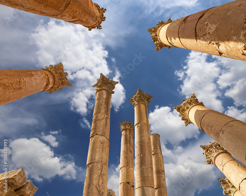 Roman Columns in the Jordanian city of Jerash (Gerasa of Antiquity), capital and largest city of Jerash Governorate, Jordan. Against the background of a beautiful sky with clouds photo