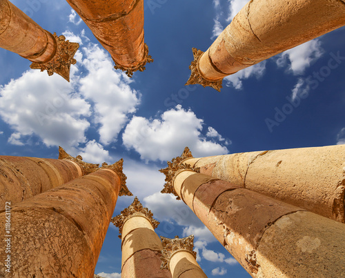 Roman Columns in the Jordanian city of Jerash (Gerasa of Antiquity), capital and largest city of Jerash Governorate, Jordan. Against the background of a beautiful sky with clouds photo