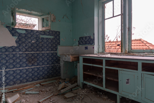 Abandoned kitchen crumbling in decaying house showing urban degradation