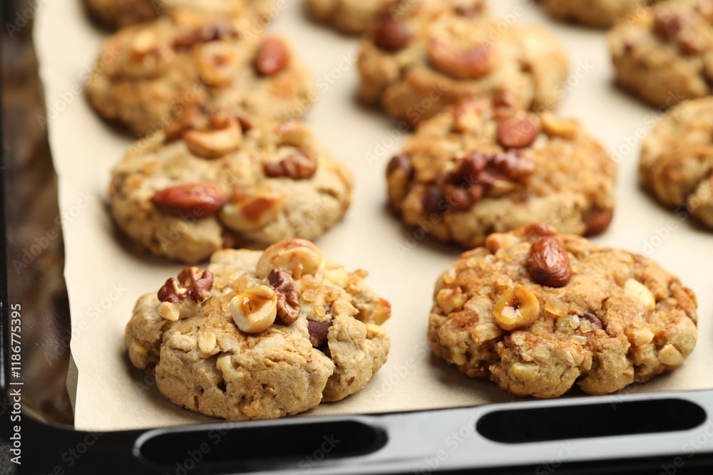 Tasty cookies with nuts in baking tray, closeup Tasty cookies with nuts in baking tray, closeup