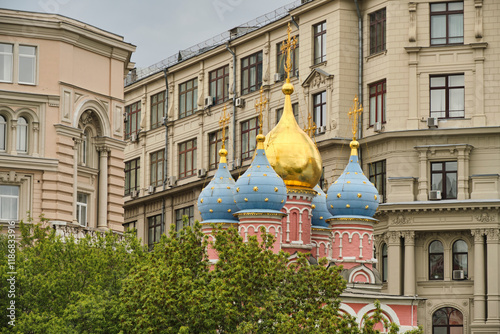 Cathedral with domes among residential buildings in Moscow.