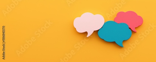 Colorful speech bubbles on a bright yellow background, symbolizing communication, conversation, and dialogue.