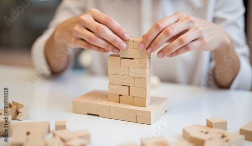 A Close-Up of Hands Building a Wooden Structure