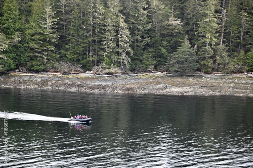 A zodiak full of people head out for a day of whale watching in Alaska photo