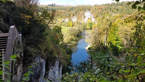 Inzigkofen, Germany - 10 16 2021: Autumnal view of the Devil's Bridge near Inzigkofen. The Danube river is floating in the valley below it.