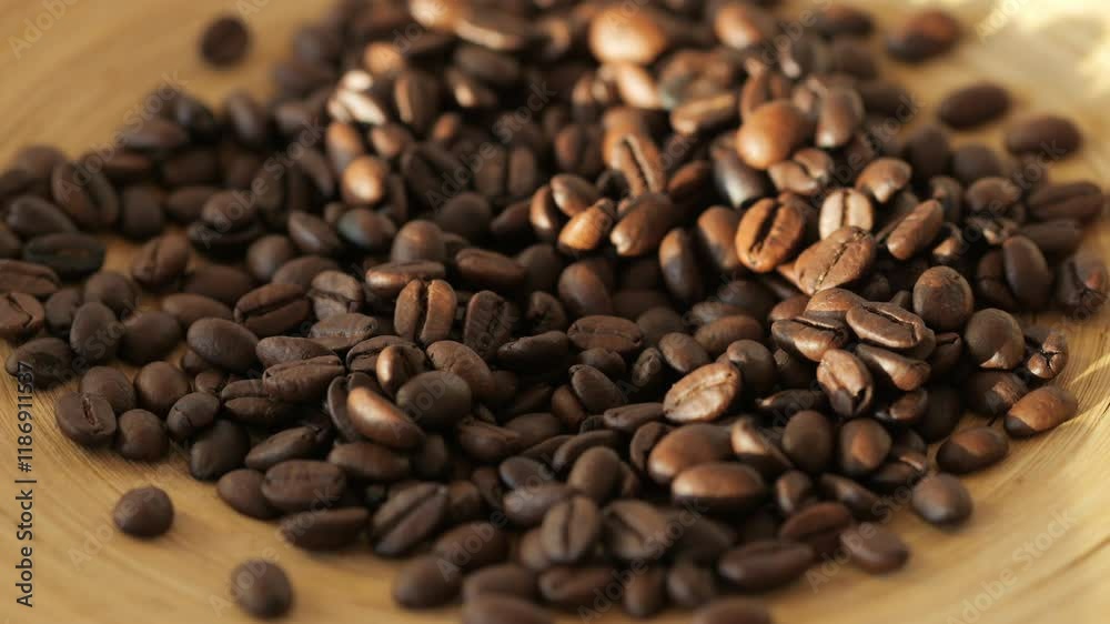 A pile of coffee beans on a wooden plate. The beans are of different sizes and are scattered all over the plate A pile of coffee beans on a wooden plate. The beans are of different sizes and are scattered all over the plate