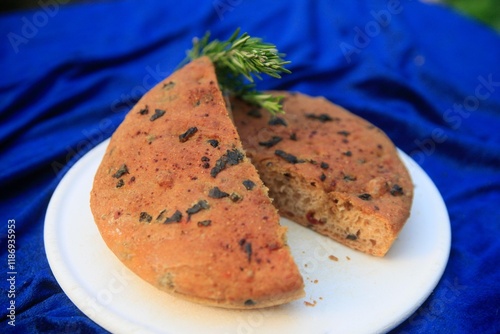 Handmade bread with herbs on a plate photo