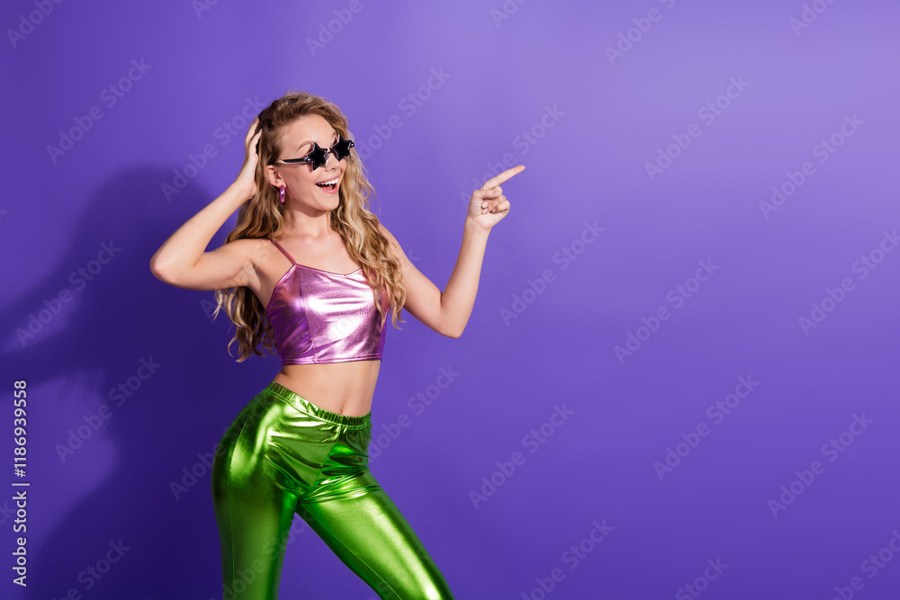 Joyful young woman in vibrant fashion outfit poses against a vivid purple background Joyful young woman in vibrant fashion outfit poses against a vivid purple background
