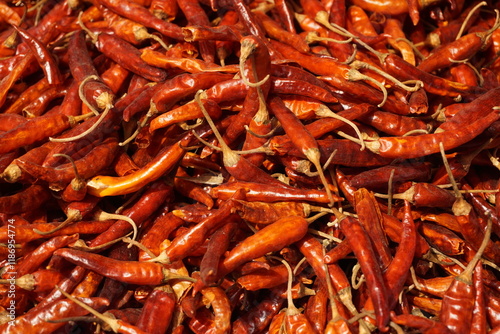 A heap of dry red chili pepper is displayed in a spice market, Dried spicy red chilies are on sale, Showcase of spicy red chili in a spice shop in Asia for the spice trade